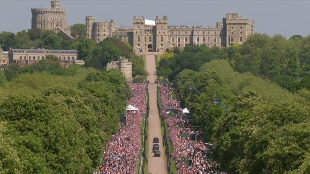 Người dân và du khách vây kín hau bên đường reo hò khi đoàn xe chở cô dâu tiến về lâu đài Windsor.