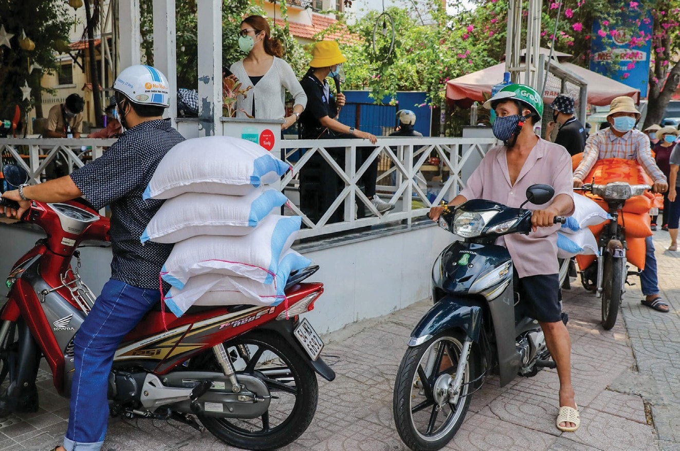 Việc làm ý nghĩa của anh Tuấn Anh nhanh chóng được nhiều ủng hộ, từng dòng xe máy chở từ gạo liên tục chạy vào kho chứa của công ty. Ảnh: Quỳnh Trần