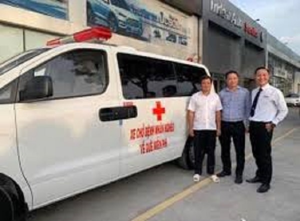 Ông Hải bên xe cứu thương chở người nghèo tại bệnh viện.