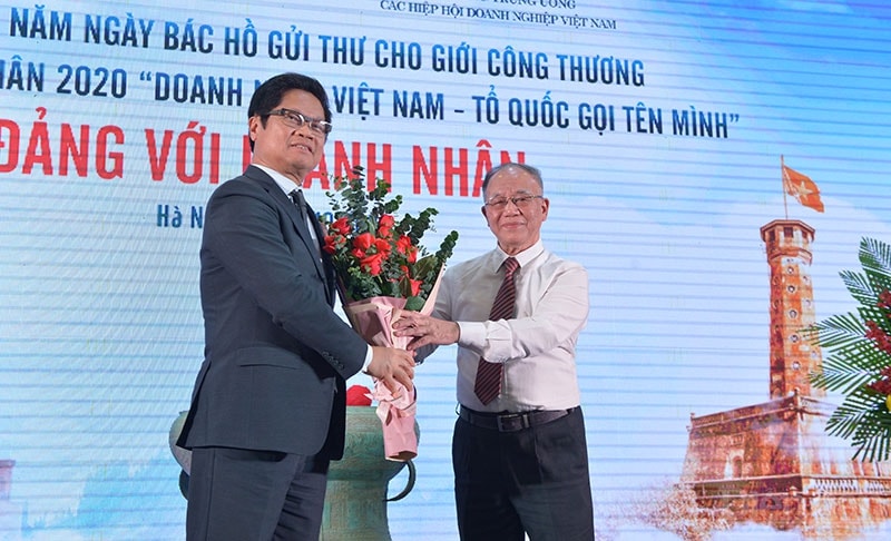 TS Vũ Tiến Lộc tặng hoa GS Hoàng Trí Bảo.