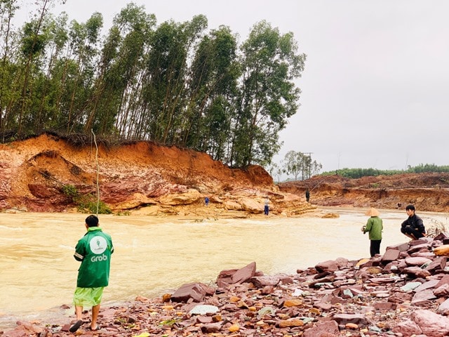 Những quả đồi bị sạt lở hai bên, cây cối ngổn ngang nhưng người dân vẫn liều mình đứng câu cá.