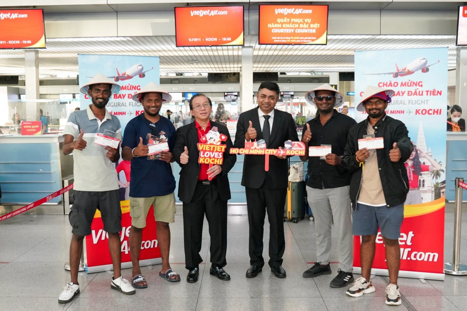 A1: Ông Đỗ Xuân Quang - Phó Tổng giám đốc Vietjet (thứ 3 từ trái sang) và ông Madan Mohan Sethi - Tổng Lãnh sự Ấn Độ tại TP. Hồ Chí Minh (thứ 4 từ trái sang) chào mừng các hành khách đầu tiên trên chuyến bay kết nối TP. Hồ Chí Minh và Kochi (Ấn Độ) tại sân bay Tân Sơn Nhất