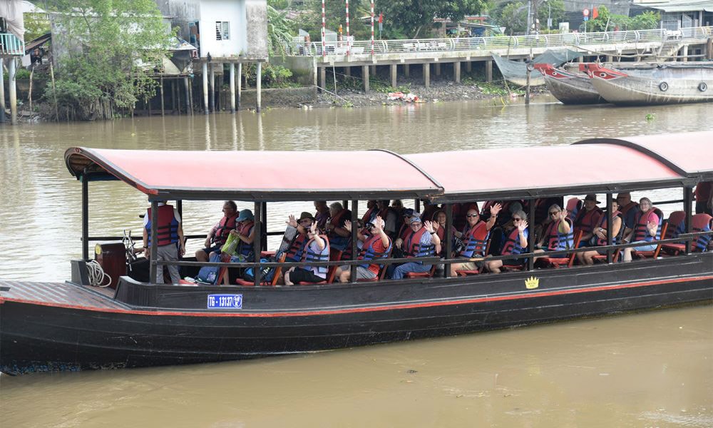 Du khách quốc tế đi tàu đến tham quan Làng cổ Đông Hòa Hiệp